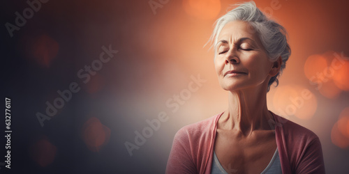 An older, mature and friendly elegant woman meditating and doing yoga with calm and serene demeanor.