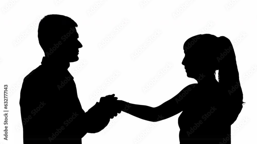 Silhouette of a man and woman greeting each other by the hand Silhouette of a man and woman greeting each other by the hand