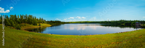 Tranquil summer landscape and cloudscape over Town of Truro Reservoir at Victoria Park in Truro, Nova Scotia, Canada