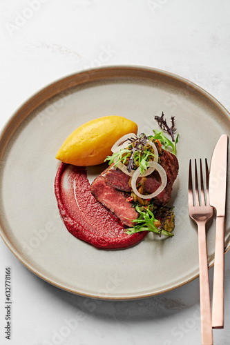 Lamb backstrap fillet, sweet potato mash, blood plum romesco, pickled white onion, green olive & coriander salsa photo