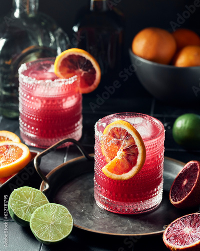 Two Glasses of Blood Orange Pomegranate Margaritas on a Dark Background