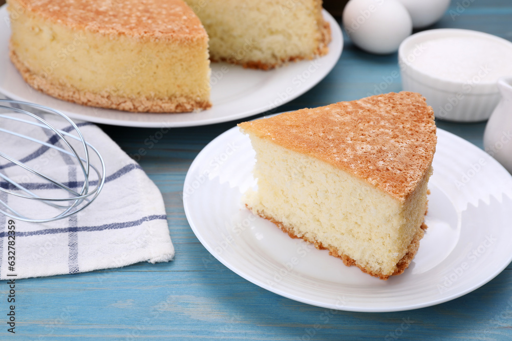 Piece of tasty sponge cake on light blue wooden table Piece of tasty sponge cake on light blue wooden table