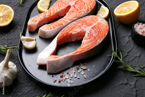 Fresh raw salmon steaks wit...