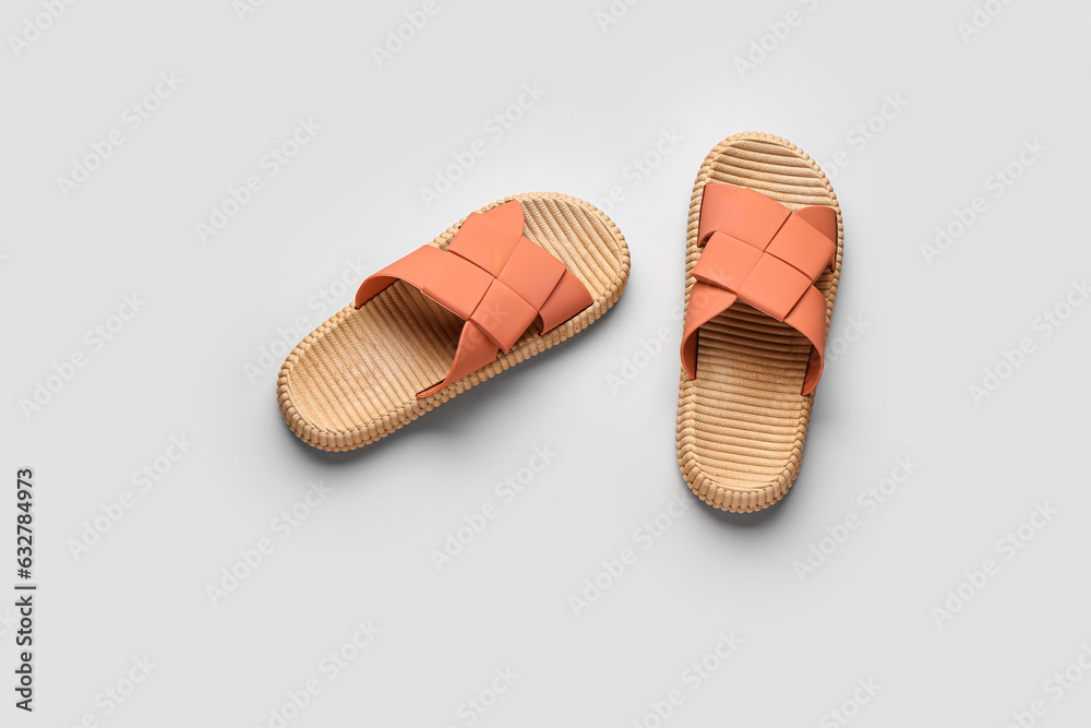 Female stylish flip flops on beige background Female stylish flip flops on beige background