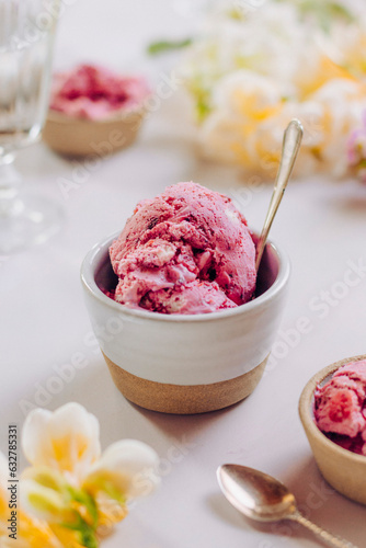 Bowl of pink berry ice cream with flowers photo