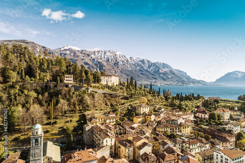 Aerial view of Bellagio village on Como lake with blue sky and the Alps in the background, Bellagio, Como, Italy