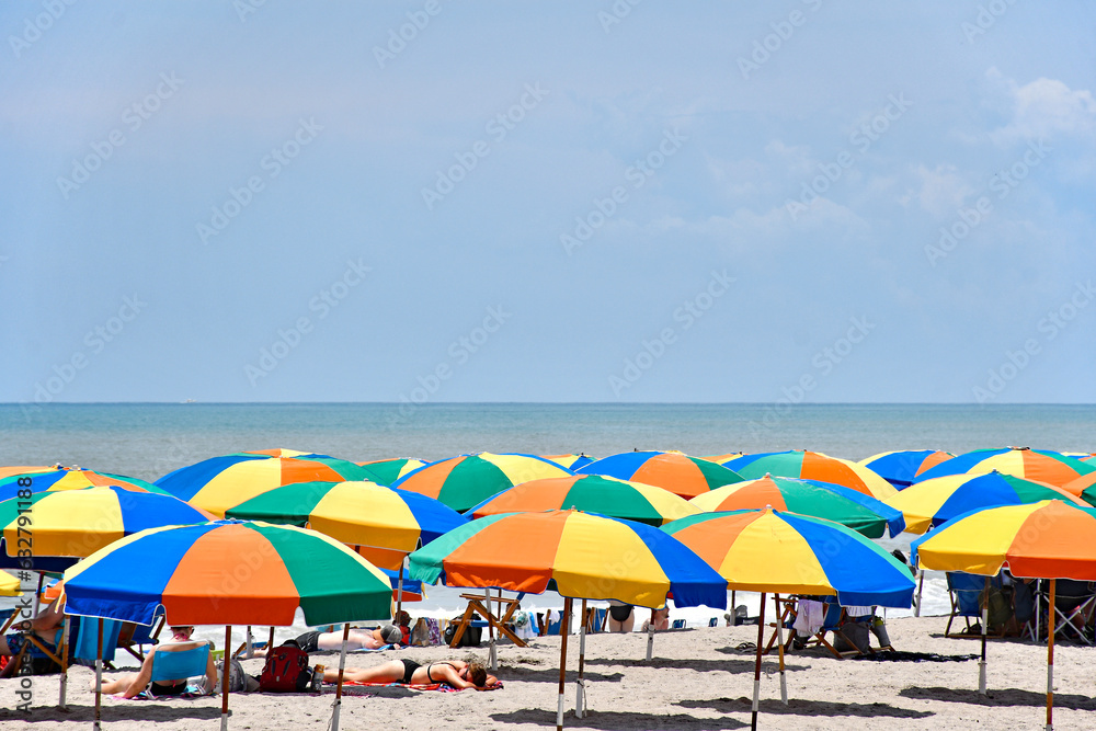 Colorful umbrellas for rent on Cocoa Beach, Florida near Cape Canaveral in Brevard County also known as the Space Coast.	
