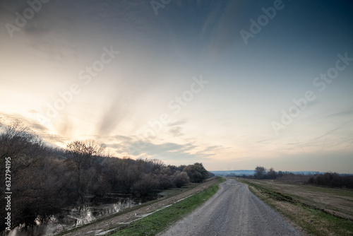 Panorama of a dyke over the danube river at dusk in Ivanovacka ada, an island in ivanovo, serbia, in vojvodina, in eastern europe, during a cold winter.