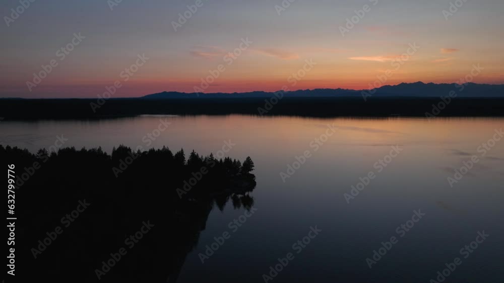 Aerial view of Herron Island at sunset with the Cascade Mountains off in the distance. Aerial view of Herron Island at sunset with the Cascade Mountains off in the distance.