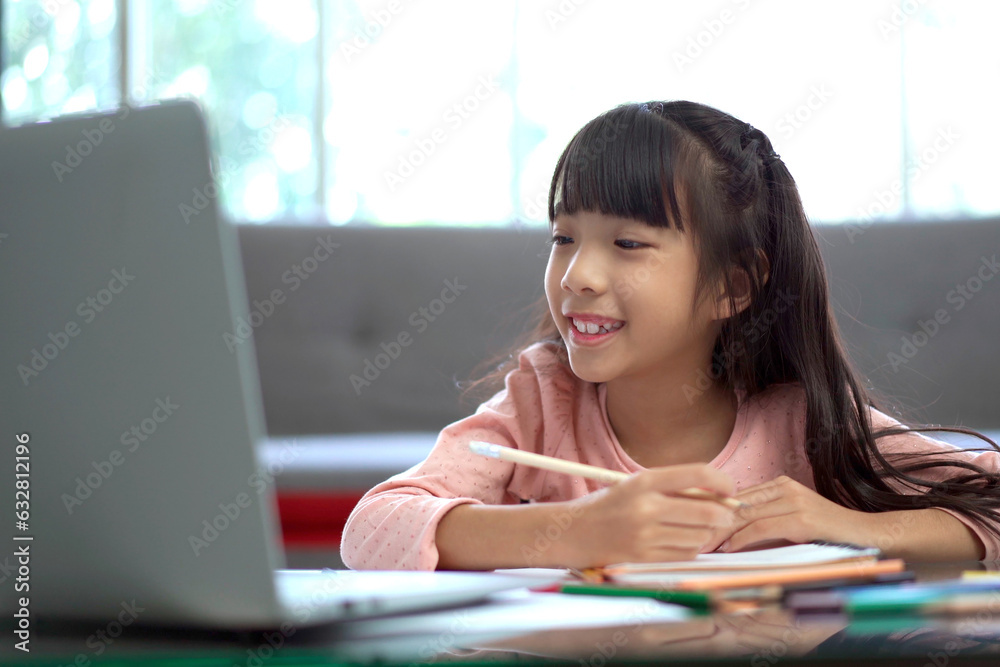 Happy Asian woman and her daughter staying together in living room, mother let her daughter learning or studying in the internet. Happy Asian woman and her daughter staying together in living room, mother let her daughter learning or studying in the internet.
