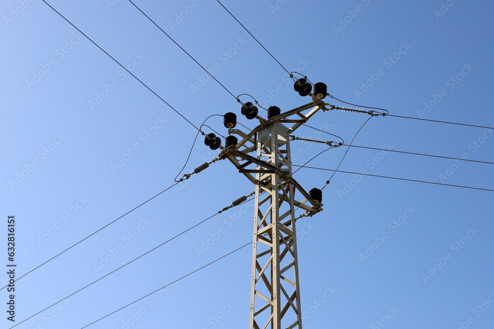Power electric pole with line wires on insulators.