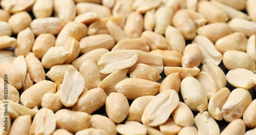 Whole shelled peanut nuts kernels close-up on rotating platform Whole shelled peanut nuts kernels close-up on rotating platform