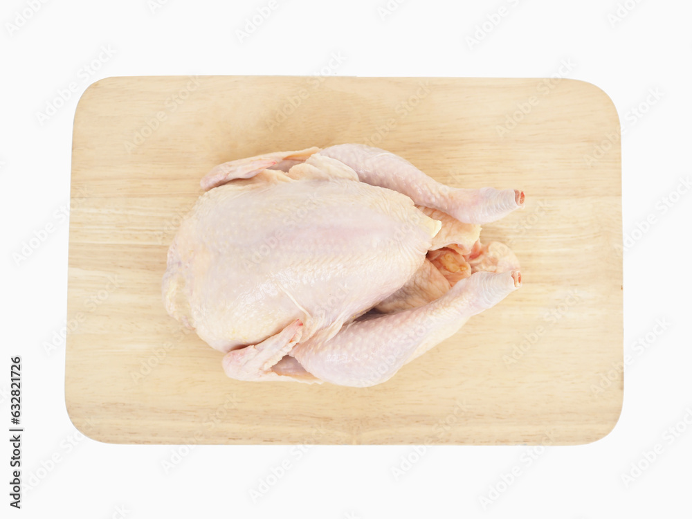Whole raw chicken on wooden cutting board on white background.