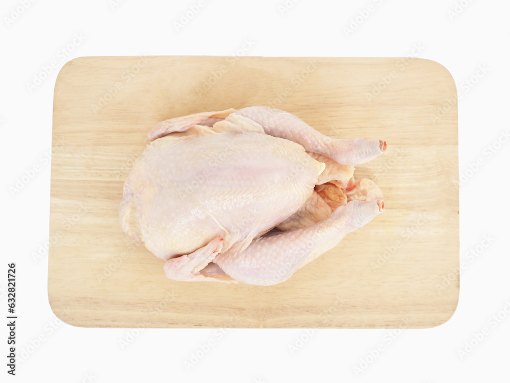 Whole raw chicken on wooden cutting board on white background. Whole raw chicken on wooden cutting board on white background.