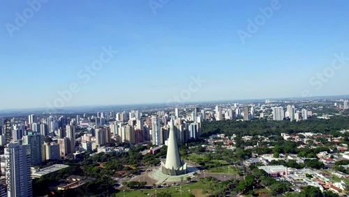 Skyscrapers and skyline of the city below. Cathedral of Maringá. Aerial photo