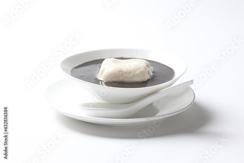 chef boiled cook thick black sesame sweet hot soup with soya milk pudding jelly in white bowl asian Chinese traditional dessert halal food vegan menu for hong kong cafe