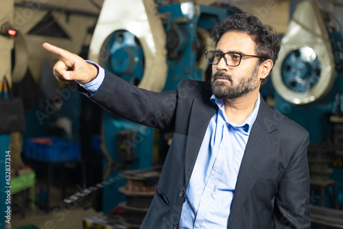 Принти на полотні Indian businessman standing at factory