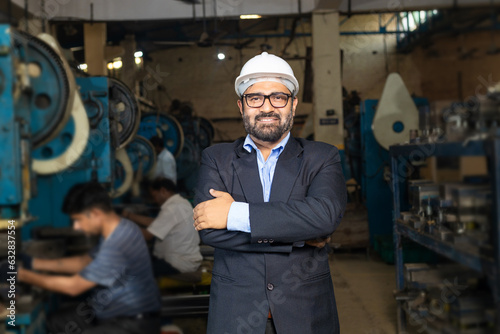 Indian businessman standing at factory © Niks Ads