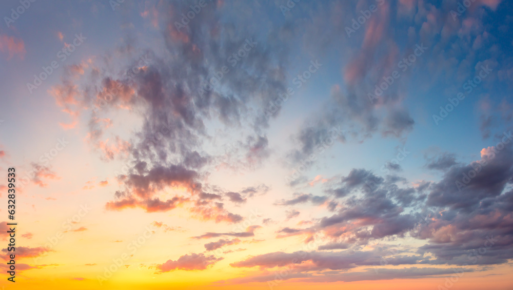 Fototapeta premium Amazing real sky - Vibrant colors Panoramic Sunrise Sundown Sanset Sky with colorful clouds. Without any birds. Natural Cloudscape background.