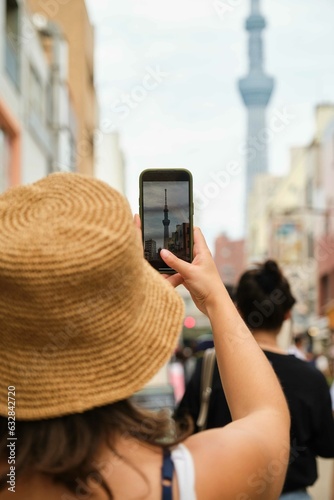 Photography Tourist woman taking a photo with the smartphone at the Tokyo Skytree in Japan