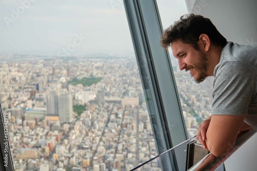 Sticker Latin tourist man enjoying the views at the Tokyo Skytree, Japan.