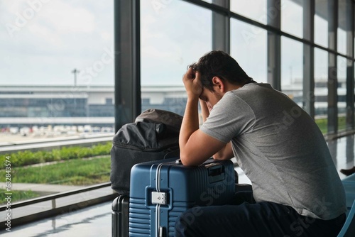 Obraz na płótnie Frustrated man at Narita airport, annoyed because his flight was canceled. w salonie