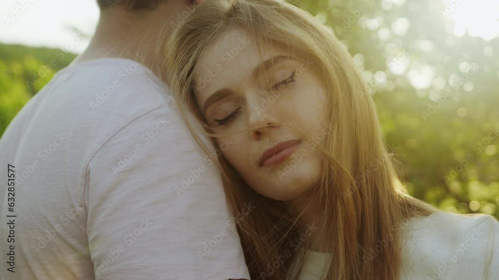 Closeup of smiling calm woman leaning head on Caucasian boyfriend shoulder outdoors. Cropped view. Happy family. Closeup of smiling calm woman leaning head on Caucasian boyfriend shoulder outdoors. Cropped view. Happy family.