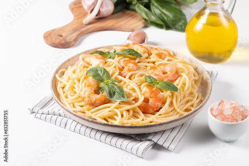 Italian pasta spaghetti with soft cheese sauce with shrimp or prawns on a plate