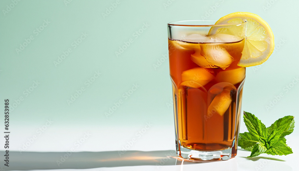 Ice tea isolated on bright background with shadow. Closeup glass of ice tea decorated with mint and lemon Ice tea isolated on bright background with shadow. Closeup glass of ice tea decorated with mint and lemon