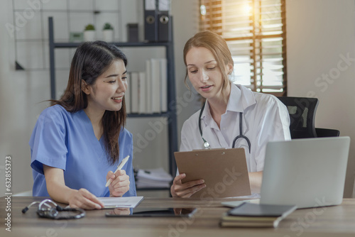 Two female doctor working at desk in clinic office, Teamwork in medicine and healthcare concept.