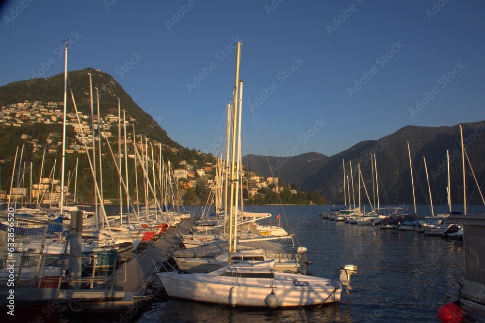 boats sailboats on the pier on the lake in lugano switzerland