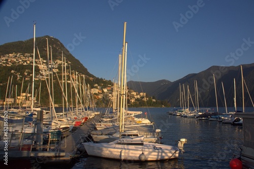 boats sailboats on the pier on the lake in lugano switzerland