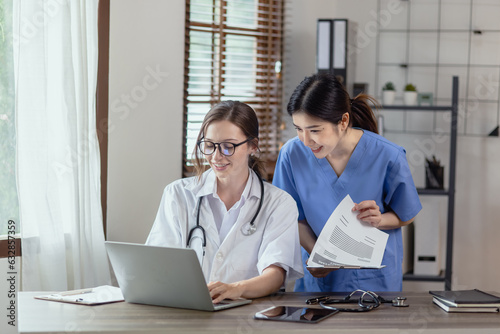 Two female doctor working at desk in clinic office, Teamwork in medicine and healthcare concept.	