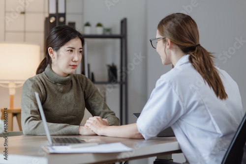 female doctor with female patient and telling advices sitting at workplace in clinic office, Healthcare and medical concept. 