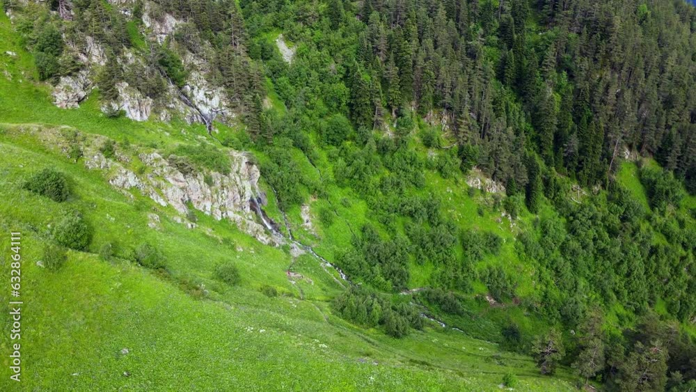 Aerial view of mountains and highland green valley with forest