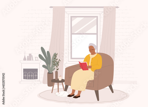 One Smiling Senior Black Woman Sitting On Sofa Reading Book At Home. Full Length.