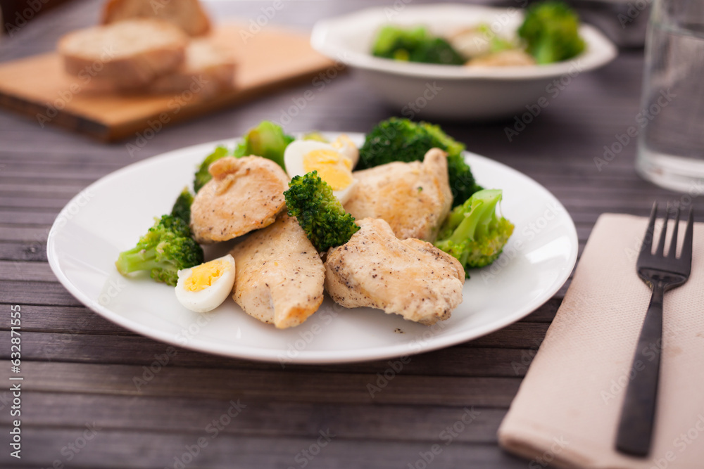Healthy snack of chicken pieces with broccoli and quail eggs in a bowl Healthy snack of chicken pieces with broccoli and quail eggs in a bowl