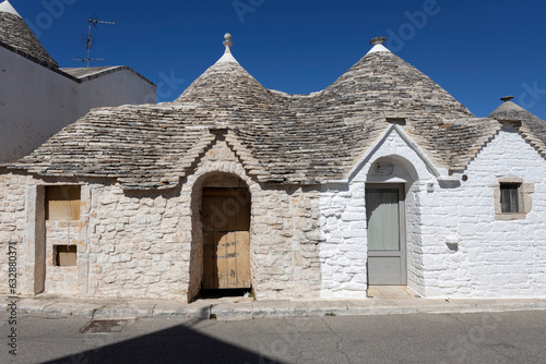 ALBEROBELLO, ITALY , JULY 11, 2022 - The Trulli of Alberobello, the typical limestone houses in the province of Bari, Puglia, Italy