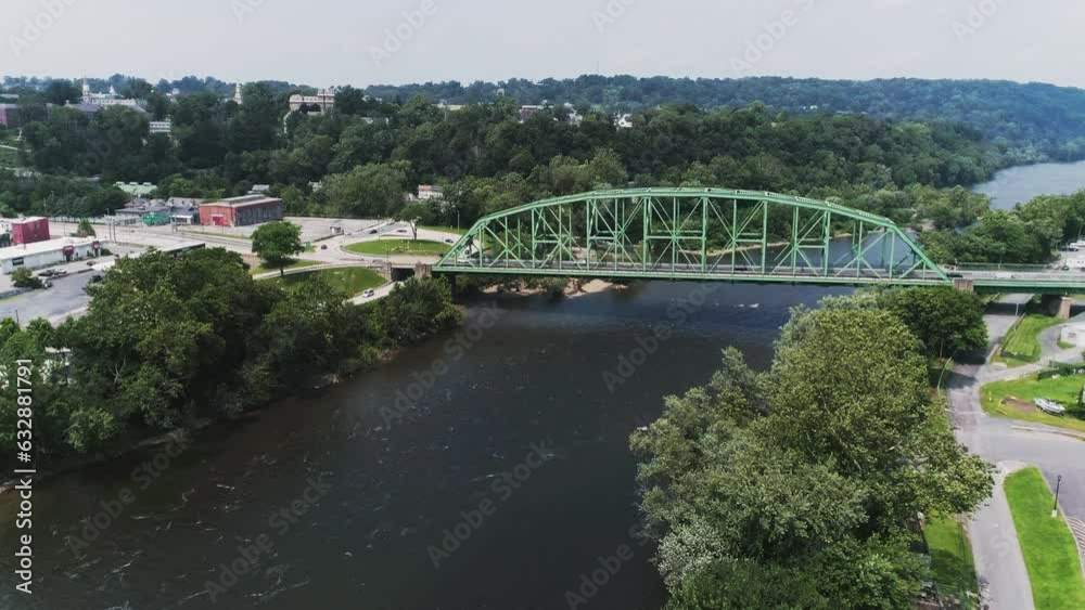 Aerial view of Easton PA and Delaware River approaching large industrial bridge with woods in the background Aerial view of Easton PA and Delaware River approaching large industrial bridge with woods in the background