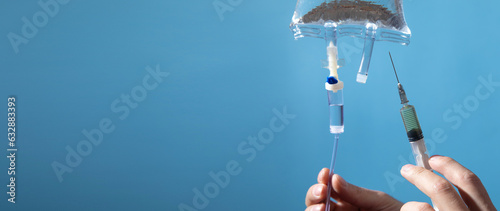 Doctor injection liquid drug to saline bag.