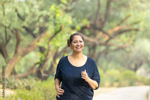 Indian woman doing jogging at park.