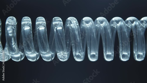 The flask is a tube with a spiral inside. Chemical reactions. Scientific experiment. Green liquid flows in a spiral into the flask.