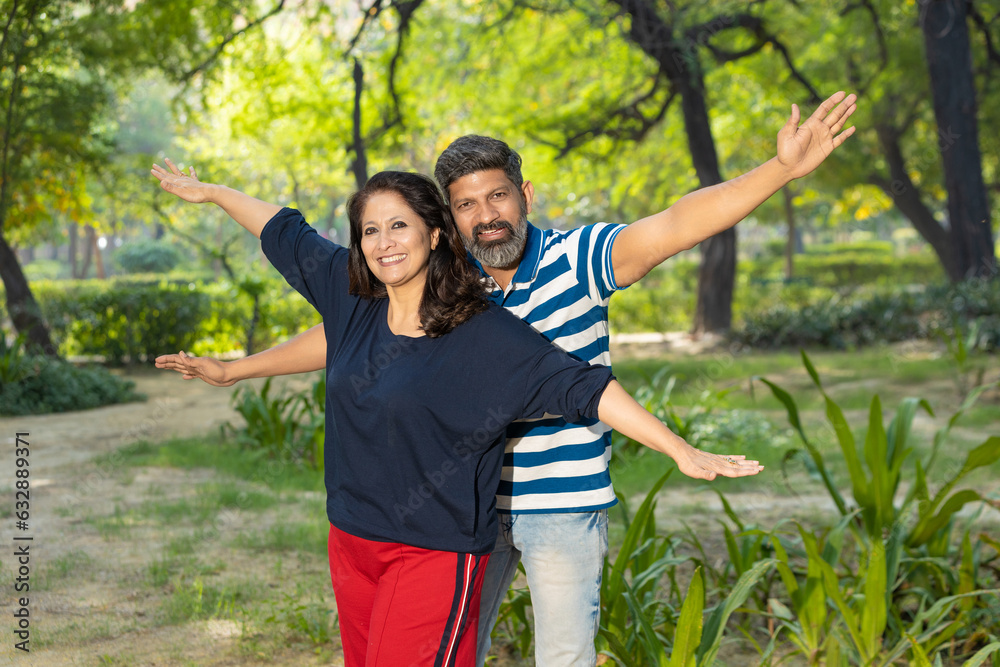 Indian couple giving happy expression at park. Indian couple giving happy expression at park.