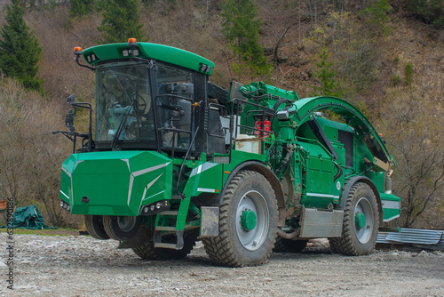 An industrial wood chipper off road capability at a forested logging site near the mountain village of Forni Avoltri in Carnia, Udine Province, Friuli-Venezia Giulia, north east Italy