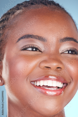 Face of black woman for skincare, beauty and smile on blue background for wellness, health and spa. Salon aesthetic, dermatology and closeup of happy person in studio with cosmetics, makeup and glow