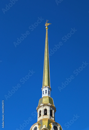 Golden spire of belfry on blue sky background. The Peter and Paul Cathedral in Peter-Pavel's Fortress in St.Petersburg, Russia