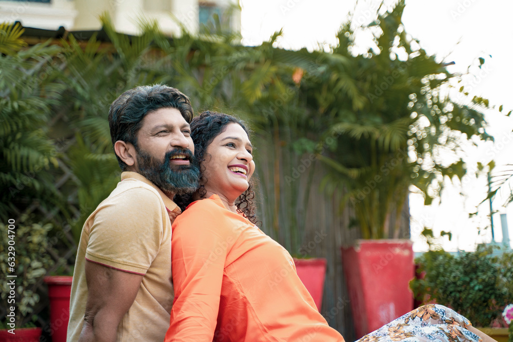 Naklejka premium Young indian couple laughing,funny and spending time to each other, at park.