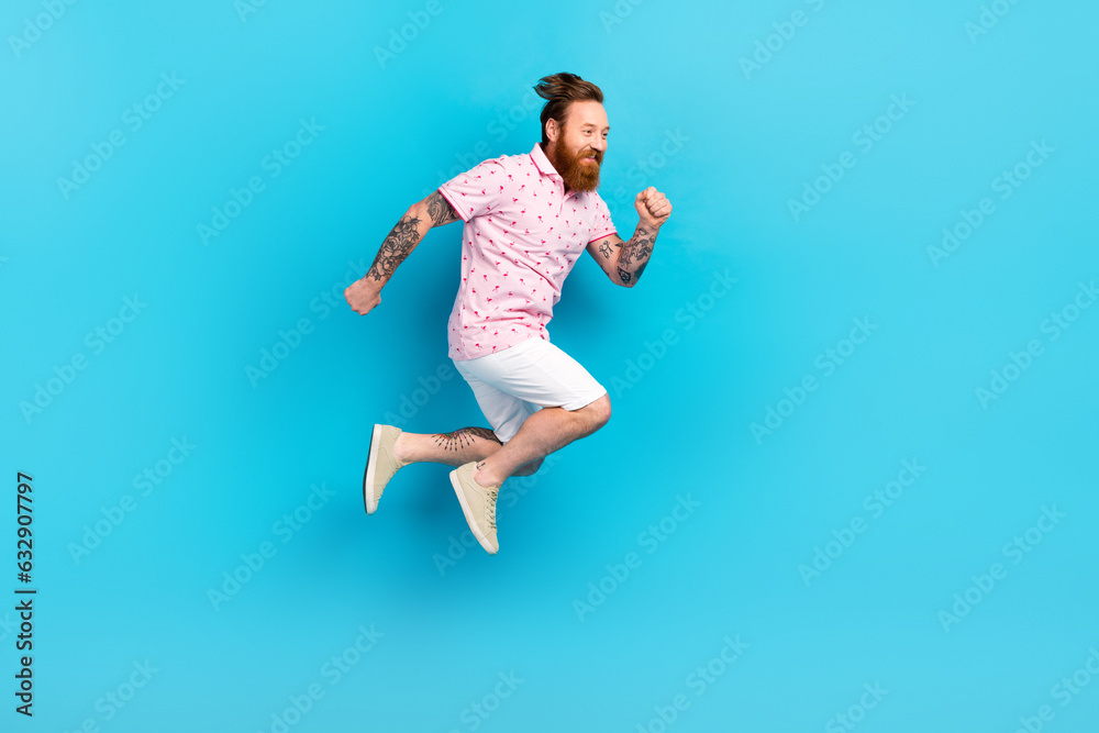 Fototapeta premium Full body profile portrait of carefree cheerful man jumping run empty space ad isolated on blue color background