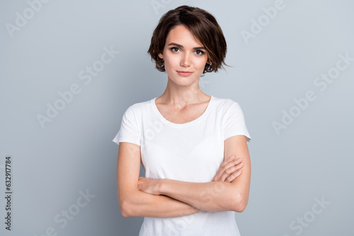 Photo of cool confident woman dressed white t-shirt smiling arms crossed isolated grey color background