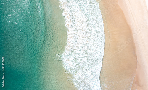 Fototapeta Naklejka Na Ścianę i Meble -  Aerial view of a beach with gentle waves and swimmers 